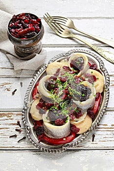 Pickled herring rolls with vegetables and dried fruits