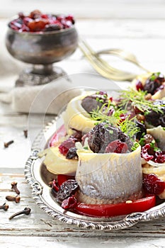 Pickled herring rolls with vegetables and dried fruits