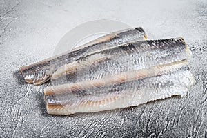 Pickled marinated sea herring fillet. White background. Top view