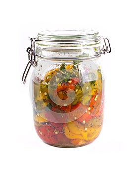 Pickled peppers in a jar. Red, yellow and green peppers in a jar