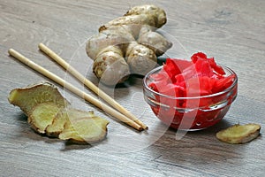 Pickled pink ginger and fresh root on the table