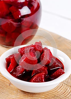 Pickled red betroot in bowl and jar photo
