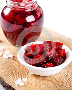 Pickled red betroot in bowl and jar photo