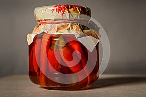 Pickled red chili peppers in glass jar
