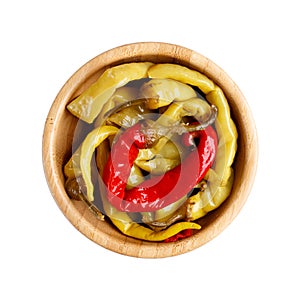 Pickled red and green hot chili peppers in wooden bowl isolated on white background
