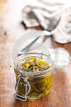 Pickled sliced jalapeno. Green jalapeno peppers in jar