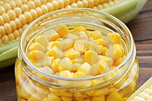 Pickled sweet corn in glass jar, fresh and cooked corn on cobs