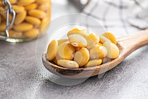 Pickled yellow Lupin Beans in wooden spoon