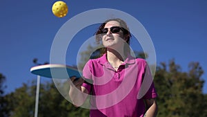 Pickler juggling with a ball on court in slow motion.