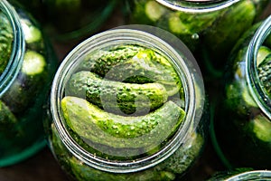 Pickles cucumbers in glass jars close up