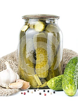 Pickles in glass jar on white