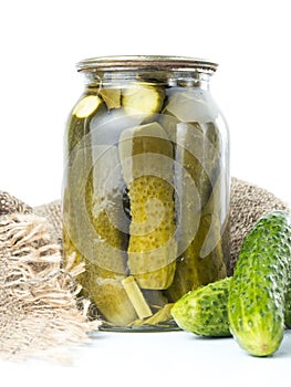 Pickles in glass jar on white