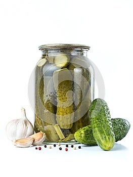 Pickles in glass jar on white