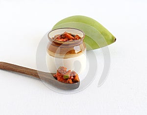 Pickles made from a Totapuri Mango on a Wooden Spoon photo