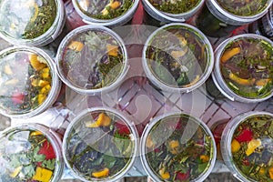 Pickles and marinades in transparent plastic jars on the table. Traditional harvesting and preservation of vegetables and crops