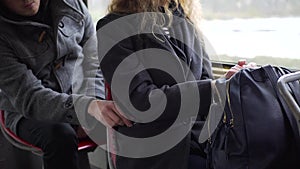 Pickpocket stealing phone from a woman`s pocket in tram or bus