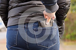 Pickpocket stealing a purse from a woman