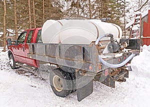 Pickup truck and maple sugar containers in bed