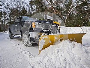 Pickup truck plowing snow