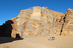 Pickup truck with tourists rides in Wadi Rum desert