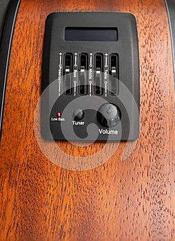 Pickup and tuner of guitar, close up shot, bass, middle and treble zone to tune sound , build on mahogany guitar side wood