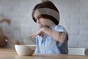 Picky angry eater kid disappointed and disgusted with meal photo