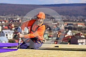 Picky inspector. new roof under construction residential building. builder use drill. professional master repair roof