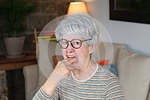 Picky senior woman gagging at home