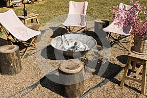 Picnic area with campfire and camping chairs around. Campsites and campfires for rural tourism. Wintertime outdoor and