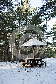 Picnic area with table in the woods in the snow