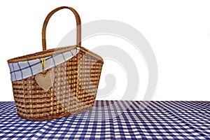 Picnic Basket On The Blue Checkered Tablecloth Isolated On White