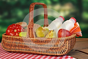 Picnic Basket With Food And Drink On The Table