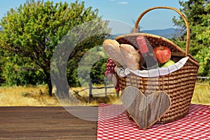 Picnic Basket With Food And Drink On The Wood Table