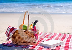 Picnic basket with fruits by the ocean