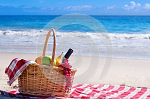 Picnic basket with fruits by the ocean