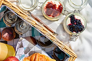 Picnic Basket With Fruits, Orange Juice, Croissants And No Bake Blueberry And Strawberry Cheesecake