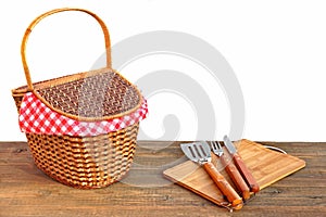 Picnic Basket And Grill Tools On The Outdoor Table Isolated