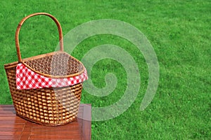 Picnic Basket On The Outdoor Rustic Wood Table Close-up