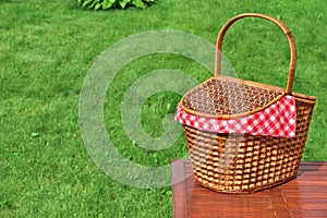 Picnic Basket On The Outdoor Rustic Wood Table Close-up