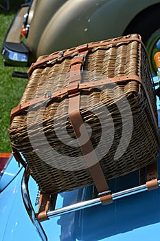 Picnic basket on rear of classic car.