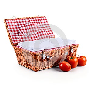 Picnic basket with red and white gingham lining wicker lid propped open to reveal contents photo