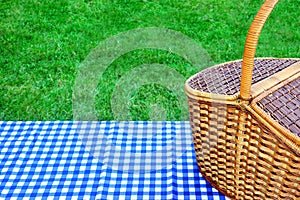 Picnic Basket On The Table With Blue White Tablecloth