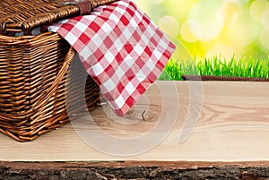 Picnic basket on the table with checked clothe photo