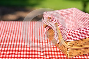 Picnic basket on a table with a red tablecloth. Summer mood. relaxation. holidays