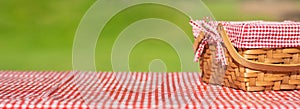 Picnic basket on a table with a red tablecloth. Summer mood. relaxation. holidays