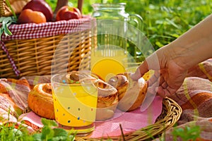 Picnic basket with wine fruit and other products on a natural wooden background. Summer rest . Camping. Picnic in nature