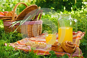 Picnic basket with wine fruit and other products on a natural wooden background. Summer rest . Camping. Picnic in nature