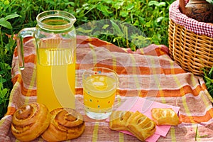 Picnic basket with wine fruit and other products on a natural wooden background. Summer rest . Camping. Picnic in nature