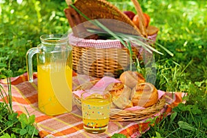 Picnic basket with wine fruit and other products on a natural wooden background. Summer rest . Camping. Picnic in nature