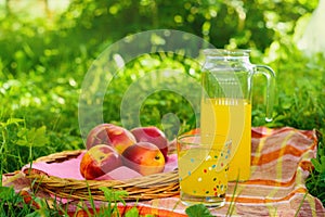 Picnic basket with wine fruit and other products on a natural wooden background. Summer rest . Camping. Picnic in nature